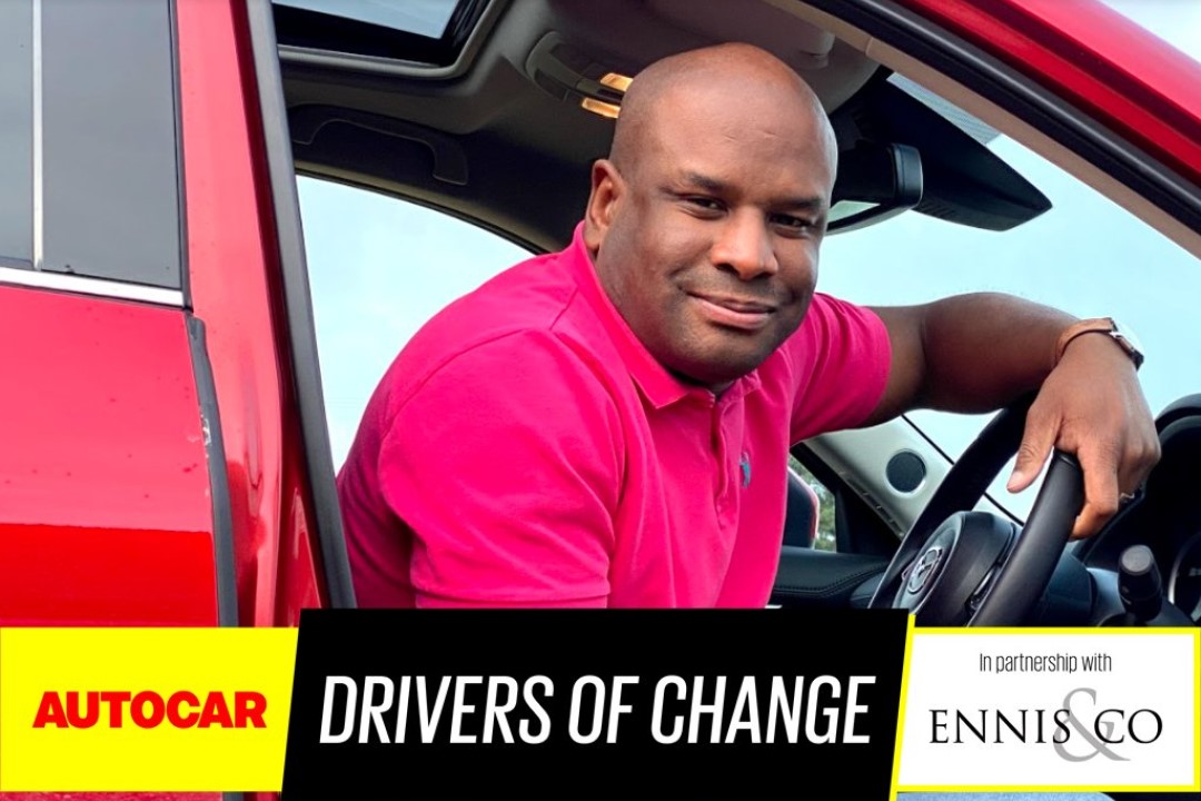 Marvin Samuels, Autocar Drivers of Change winner 2020, sitting in car with logo displayed